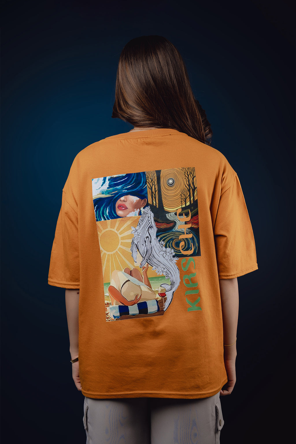 Person wearing an orange t-shirt with a graphic design on the back against a dark background
